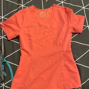 Figs XXS coral three pocket fitted scrub top.
